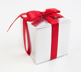 Silver gift box with red ribbon bow.