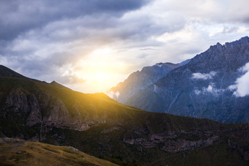 ountain panoramic view on a evening. Beautiful evening mountain landscape under bright sunset. Georgia Kazbegi