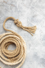 Ropes tied with knots on a gray background