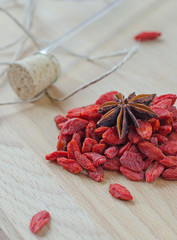 Goji berries and clove on a wooden Board.