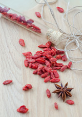 Goji berries and clove on a wooden Board.