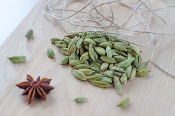 Dry aroma cardamon on the wooden board