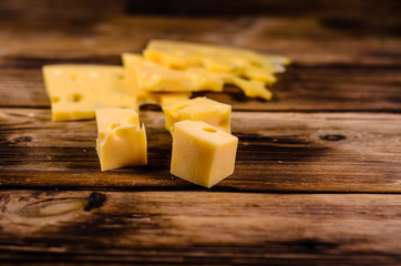 Sliced cheese on wooden table