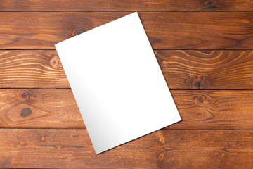 Blank book or magazine cover on wood background