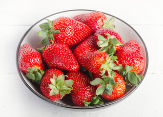 Ripe red strawberries in a bowl.