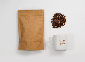 Vintage cup of coffee on white, pack coffee and coffee grains. Hipster background.