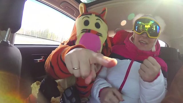 girl skier having fun with the music in the car on the trip