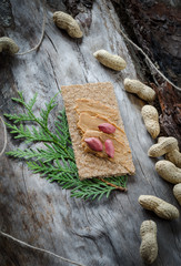 Sandwich with peanut butter on the background of old wood