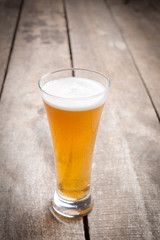 glass beer on wood background