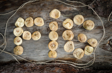 Inscription on aged wood from dried figs