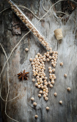 Chickpeas in a glass flask on aged wood
