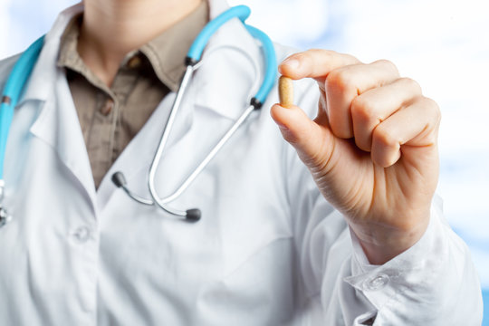 Doctor holding pills