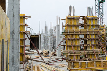 Concrete Pillars Supported With Boards on Construction Site