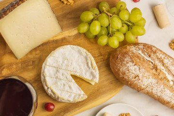 Red wine, cheese, bread and grapes, overhead photo