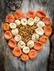 Assortment of dried figs, raisins and apricots in the form of heart.