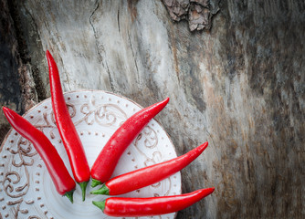 Red chillies on aged wood background