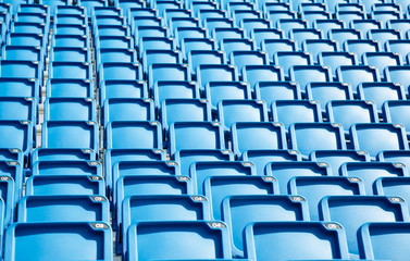 Naklejka premium Folded blue plastic chairs on a tribune