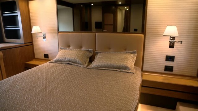Spacious double bed in the main cabin of a luxury yacht.