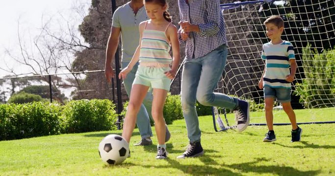 Happy family playing football