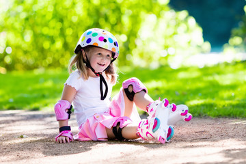 Little girl with roller skate shoes in a park