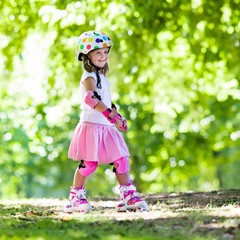 Little girl with roller skate shoes in a park