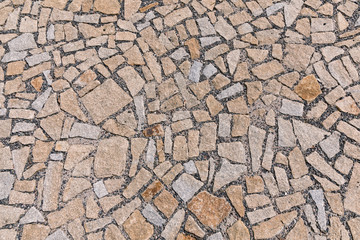 Paving blocks made of asymmetrical stone. The stone pavement as the background texture.
