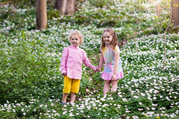 Children in spring park with flowers