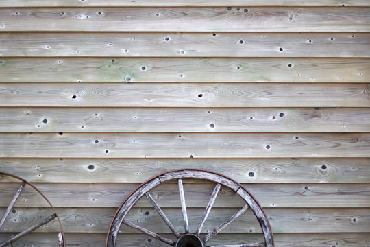 Old Antique Vintage Wood Wheel On A Wooden Texture Wall