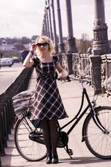 Fototapeta na wymiar Blonde girl and retro bike