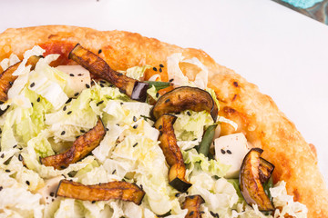 Piece of pizza with eggplants, Chinese cabbage, sesame, cheese mozzarella and tofu cheese