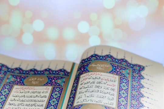 Opening pages of holy book Qur'an with lights background