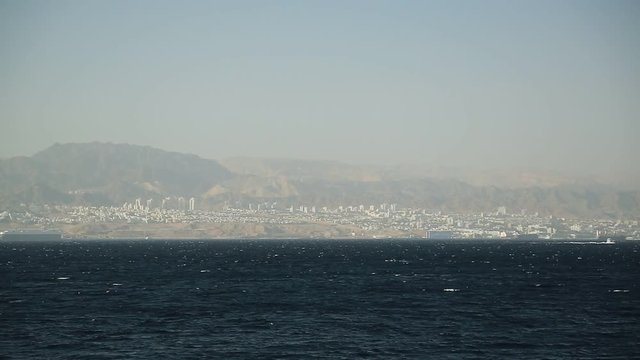 Panorama of Eilat city in Israel, Red Sea, Gulf of  Aqaba. View from Aqaba city in Hashemite Kingdom of Jordan
