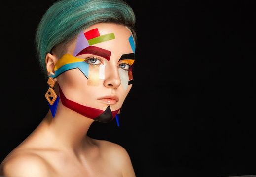Art make up. Beautiful woman with creative make up over bblue background.