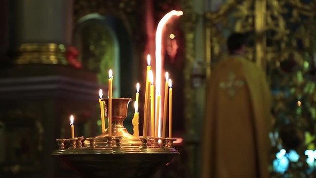 Orthodox priest is cross oneself and prays in orthodox church