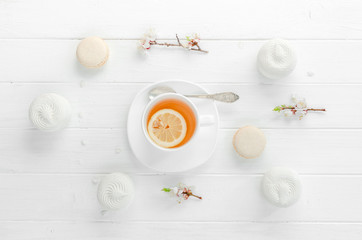Fototapeta na wymiar Tea with lemon in white porcelain dishware, topivew