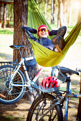 Camping with a hammock in the woods after cycling.