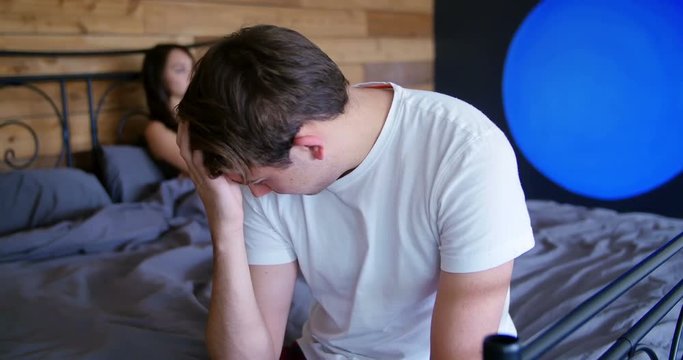 Couple ignoring each other after fight in bedroom