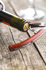 Bottle of wine with corkscrew.