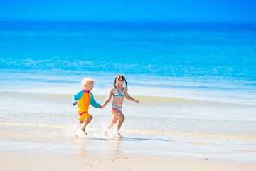 Kids run and play on tropical beach