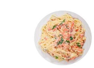 spaghetti with salmon creamy sauce. top view. isolated on white
