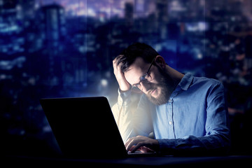 Businessman in the office at night