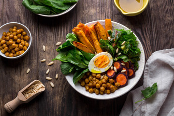 Lunch bowl with sweet potatoes, chickpeas, spinach, carrots and boiled egg - obrazy, fototapety, plakaty