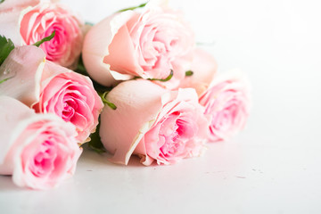 Fototapeta na wymiar Pink rose at white stone table.