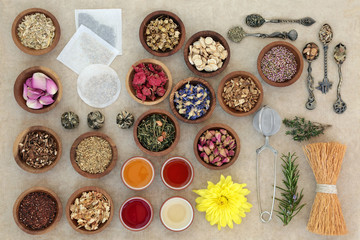 Herb Teas for Good Health. With strainer, whisk, tea bags and oriental tea cups on hemp paper background. Also used in natural alternative herbal medicine.