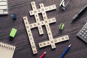Business workplace with office stuff and wooden cubes making cro