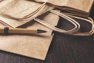 Shopping bags and pen on desk