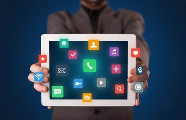 Businessman holding tablet with multimedia concept