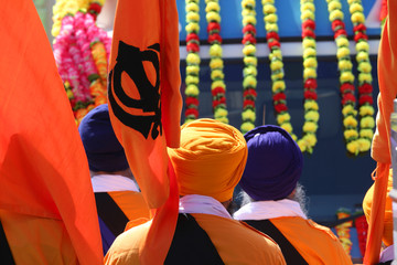 sikh men with flags during festival on the road