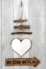 To The Beach Abstract . With heart shaped rustic wooden mobile with beach sign.