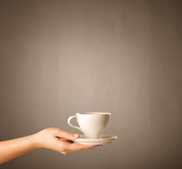 Female hand holding coffee cup